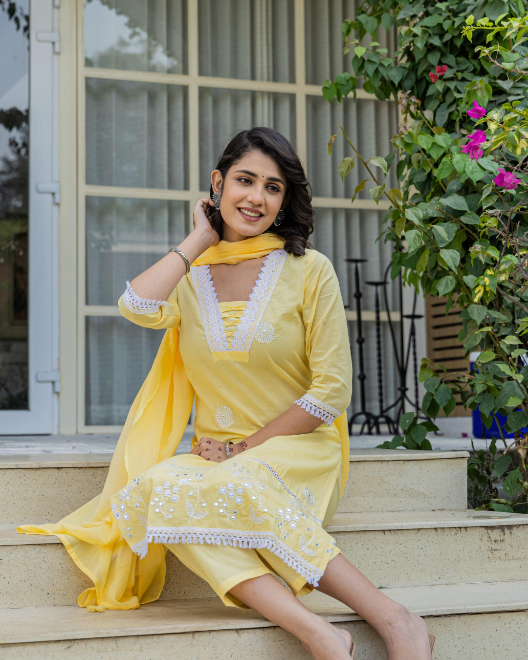 Traditional yet modern yellow kurta set, designed with floral prints and lace detailing.