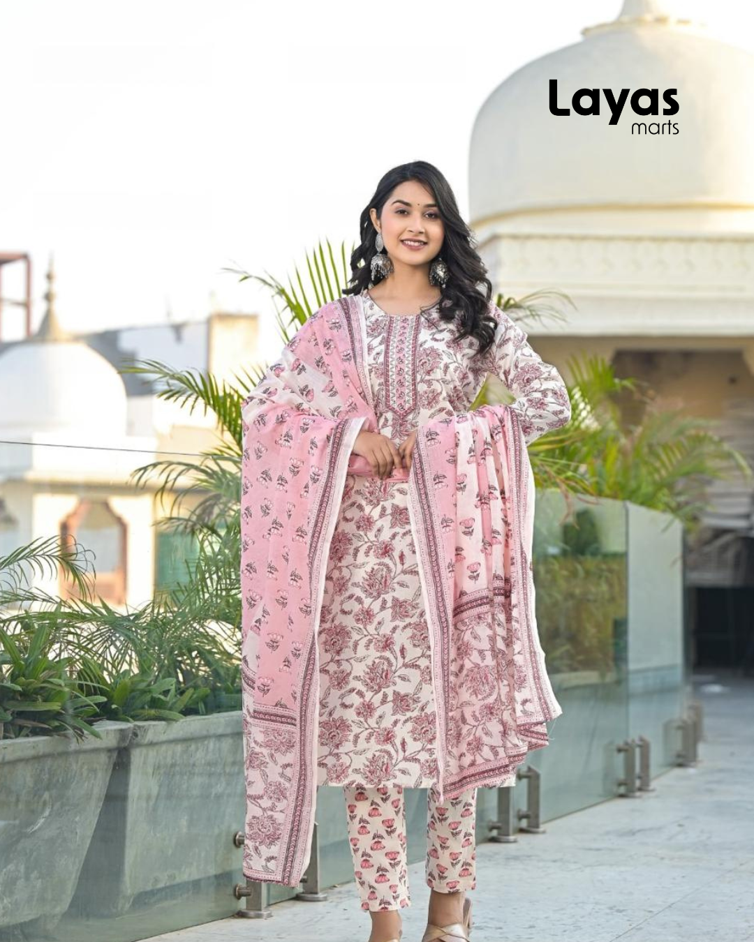 Woman wearing pink floral printed kurta with trousers and dupatta