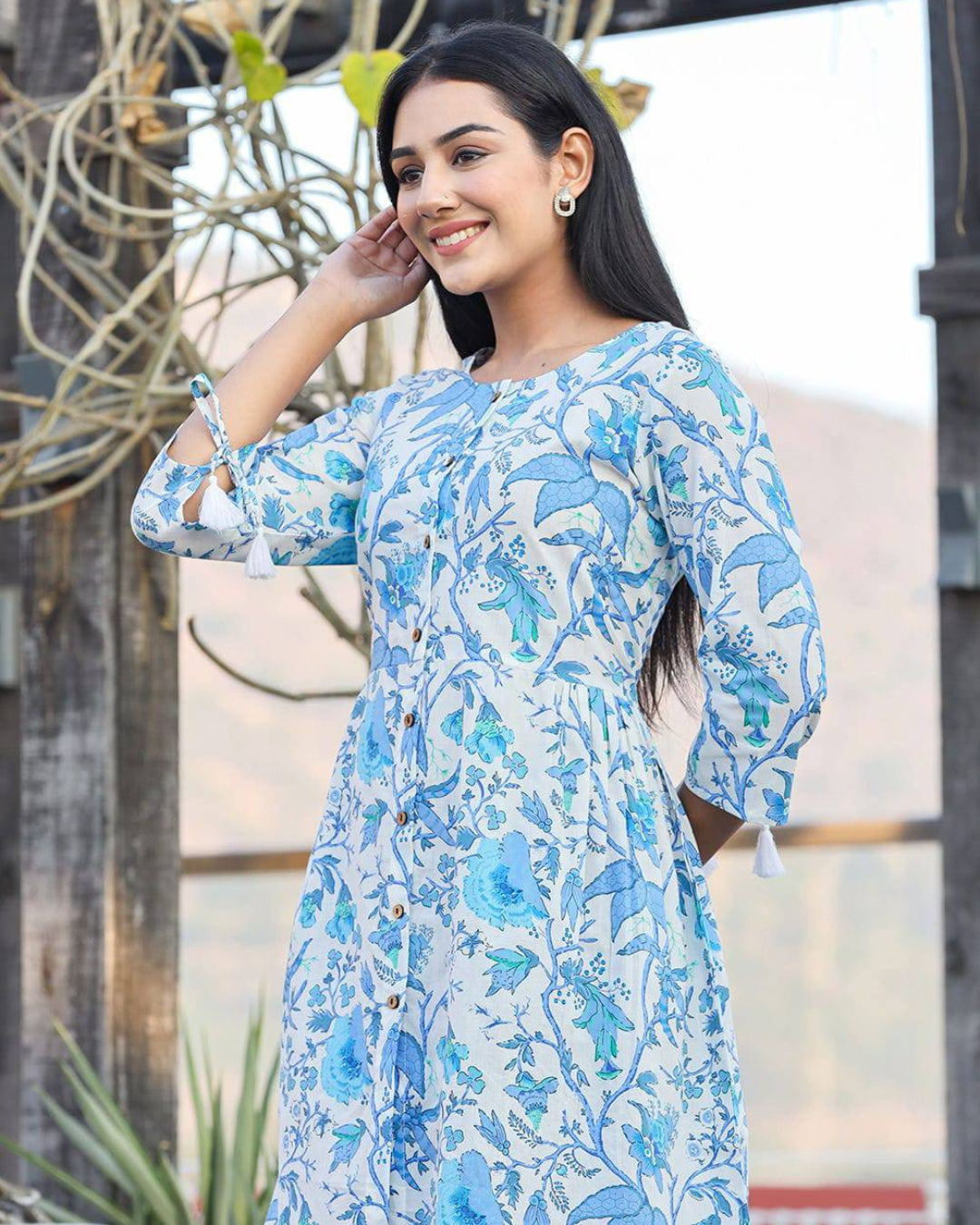 Lightweight floral-printed cotton top with round neckline, designed for casual and semi-formal styling.