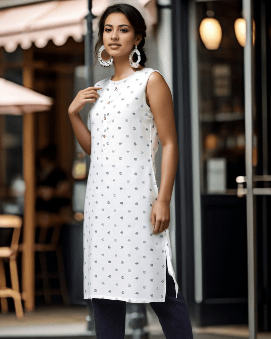Styled White Floral Sleeveless Cotton Dress, paired with sandals for a chic summer look, available online at Layas Marts
